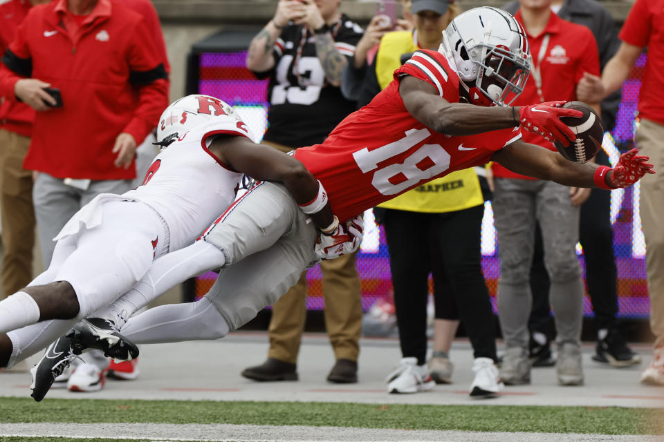 Rutgers defensive back Avery Young, left, tackles Ohio State receiver Marvin Harrison during the first half of an NCAA college football game, Saturday, Oct. 1, 2022, in Columbus, Ohio. (AP Photo/Jay LaPrete)