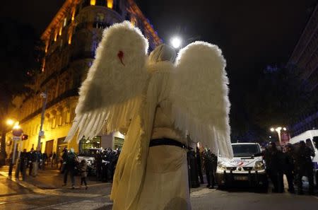 A demonstrator dressed as an angel faces French riot police officers during a rally in Marseille, October 31, 2014. REUTERS/Jean-Paul Pelissier