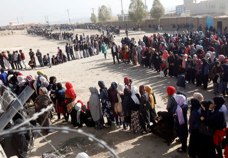 Afghans line up to cast their votes during a parliamentary election at a polling station in Kabul, Afghanistan October 21, 2018. REUTERS/Omar Sobhani