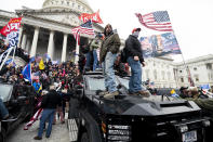 UNITED STATES - JANUARY 6: Trump supporters stand on the U.S. Capitol Police armored vehicle as others take over the steps of the Capitol on Wednesday, Jan. 6, 2021, as the Congress works to certify the electoral college votes. (Photo By Bill Clark/CQ-Roll Call, Inc via Getty Images)