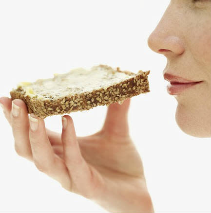 Woman eating toast and ways to eat more and lose weight