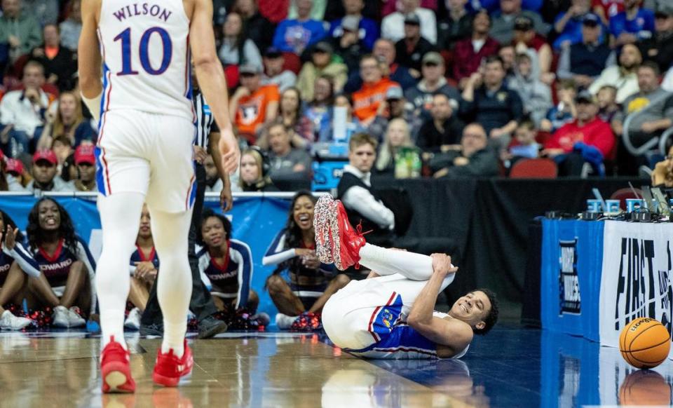 Kansas guard Kevin McCullar Jr. (15) smiles at teammate Jalen Wilson (10) after falling while trying to save the ball from going out of bounds during a first-round college basketball game against Howard in the NCAA Tournament Thursday, March 16, 2023, in Des Moines, Iowa.
