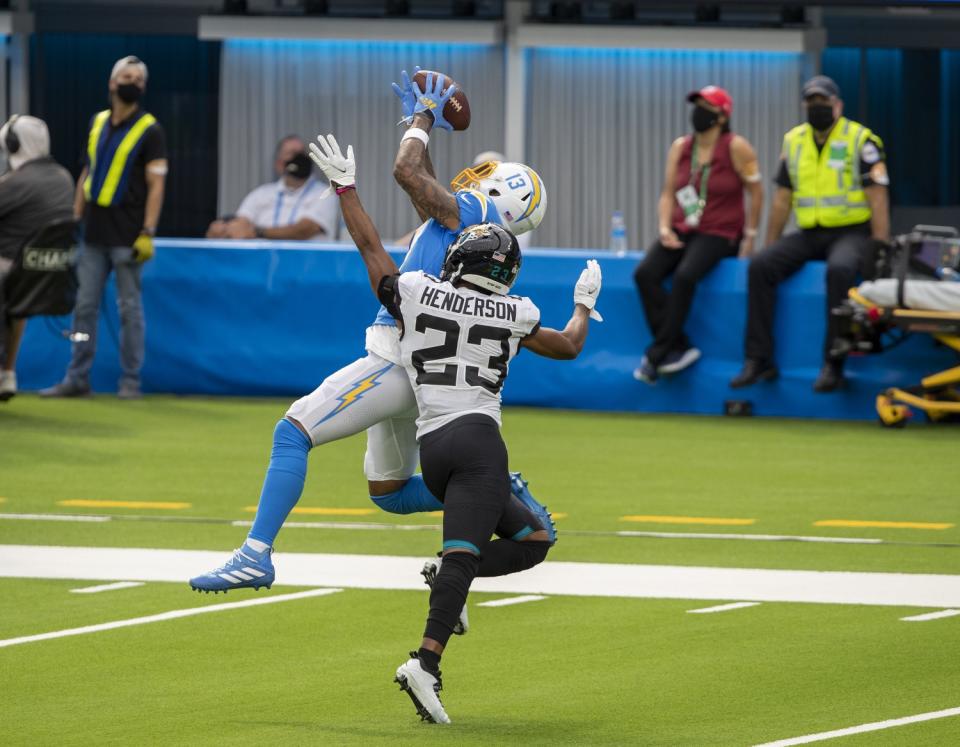 The Chargers' Keenan Allen hauls in a pass over Jaguars cornerback CJ Henderson in the first half at SoFi Stadium.