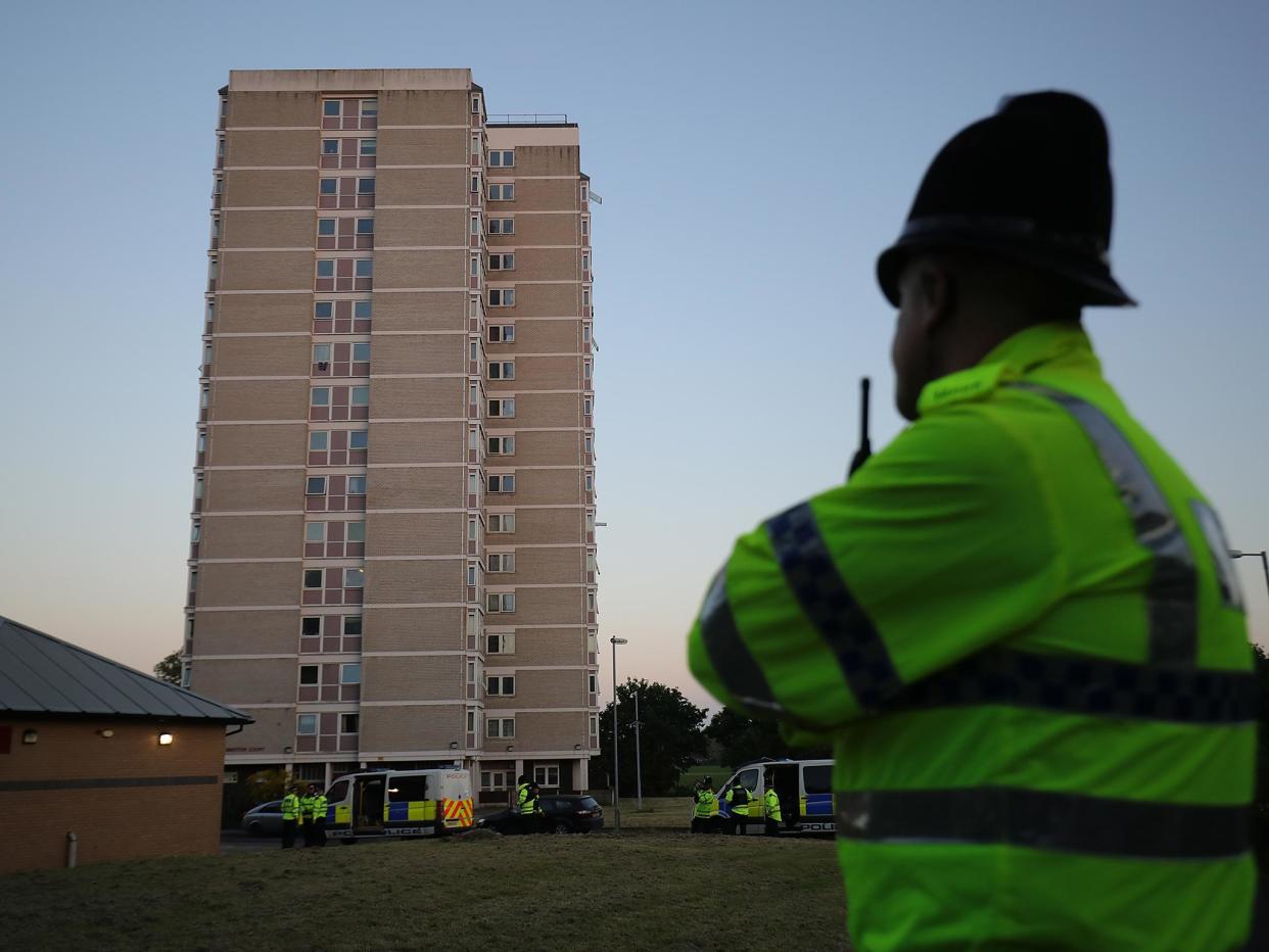 Police guard the tower block flat in Blackley where Salman Abedi is thought to have constructed his bomb: Getty Images