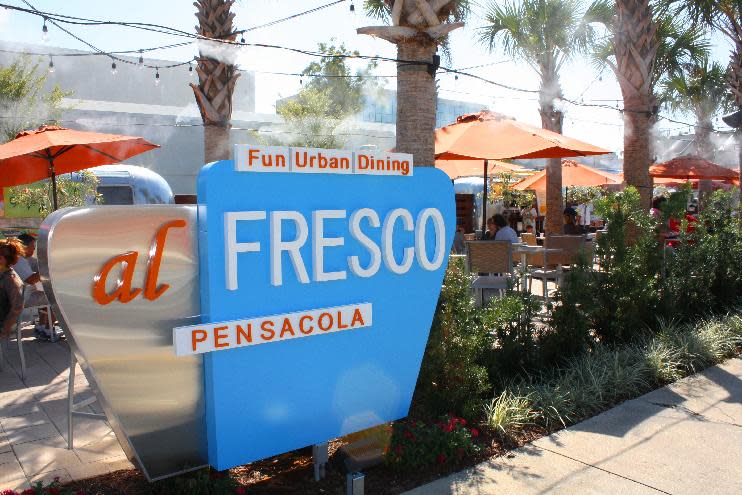 This undated image released by Visit Pensacola shows Al Fresco, an outdoor eatery where diners can order from small Airstream restaurants in downtown Pensacola. Upscale eateries and wine bars have replaced the strip clubs and pool halls that once lined the city’s main drag. Young sailors from nearby Pensacola Naval Air Station still frequent the area, but nowadays are often lured by the family friendly art and music scene rather than the bars. (AP Photo/Visit Pensacola)