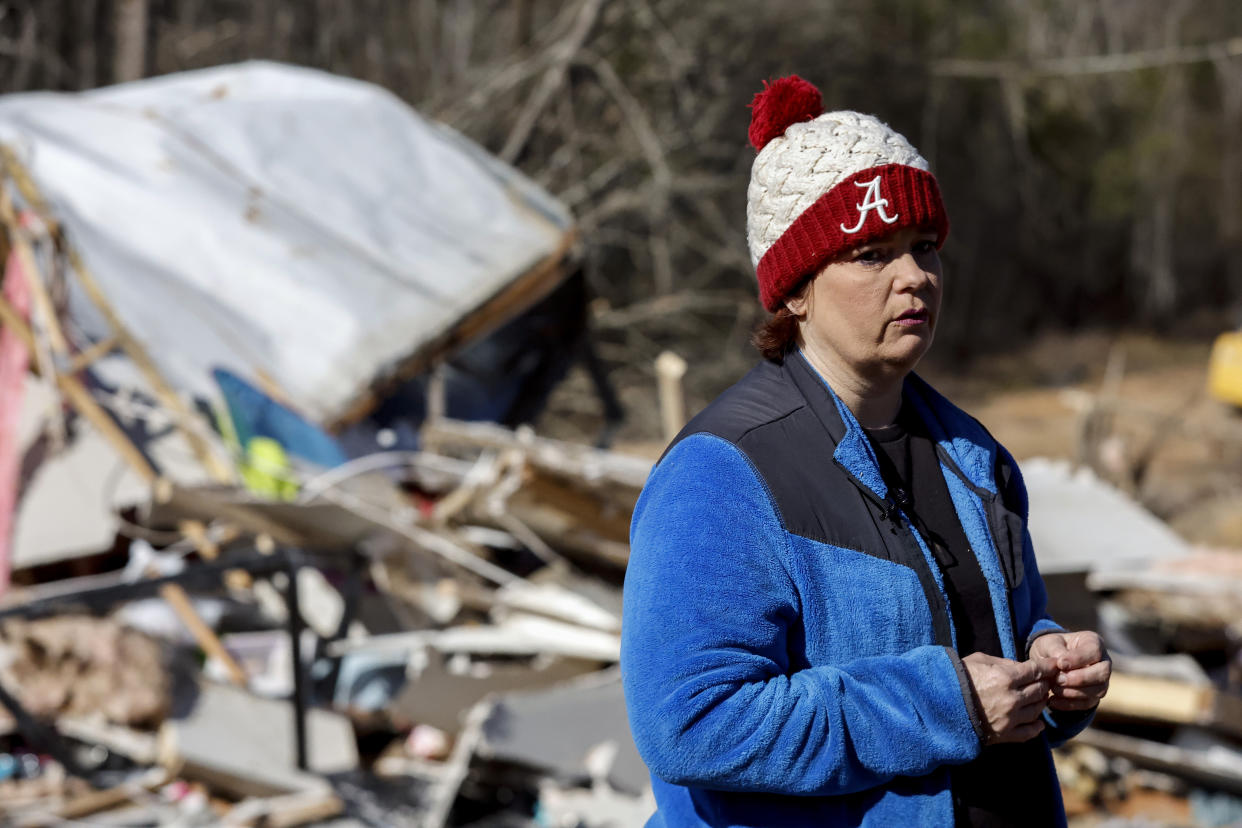 Leighea Johnson looks over what is left of her home after a tornado that ripped through Central Alabama earlier this week destroying her home on Saturday, Jan. 14, 2023 in Marbury, Ala. Her daughter and grandson where in the home and survived with minor injuries. (AP Photo/Butch Dill)