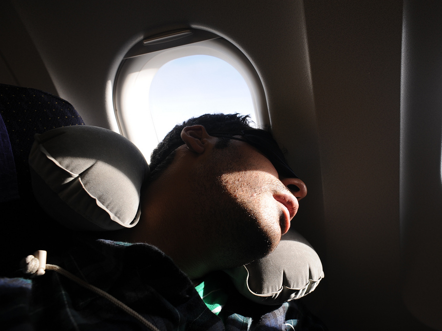 Guy sleeping in plane window seat