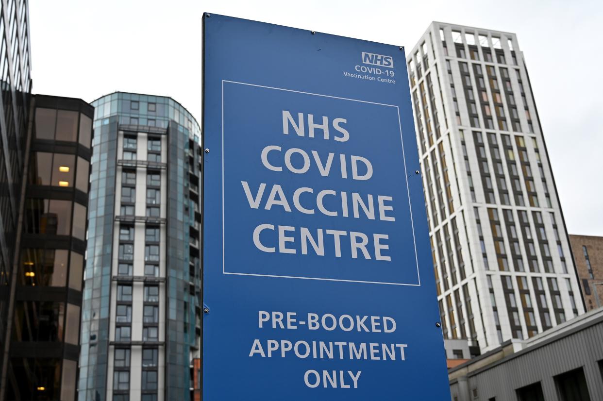 An NHS COVID-19 sign is pictured outside a Covid-19 vaccination centre in Wembley, northwest London, on January 19, 2021. - Britain on January 18 extended its coronavirus vaccination campaign to people over the age of 70, as new, tougher restrictions for all arrivals to the country came into force. (Photo by JUSTIN TALLIS / AFP) (Photo by JUSTIN TALLIS/AFP via Getty Images)