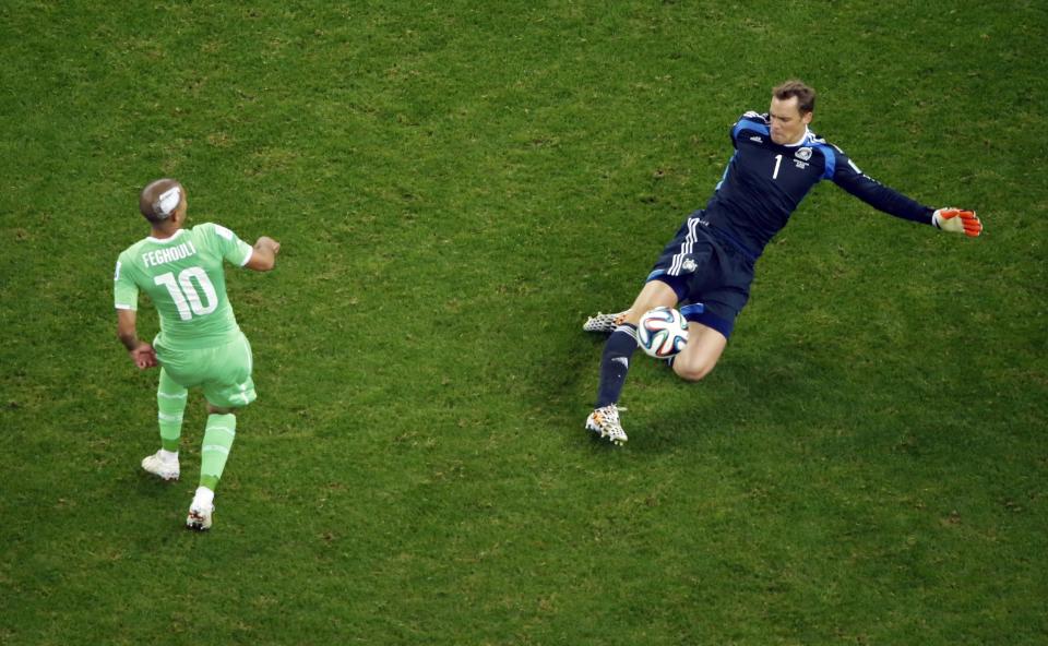 Germany's goalkeeper Manuel Neuer clears the ball from Algeria's Sofiane Feghouli during their 2014 World Cup round of 16 game at the Beira Rio stadium in Porto Alegre June 30, 2014. REUTERS/Fabrizio Bensch