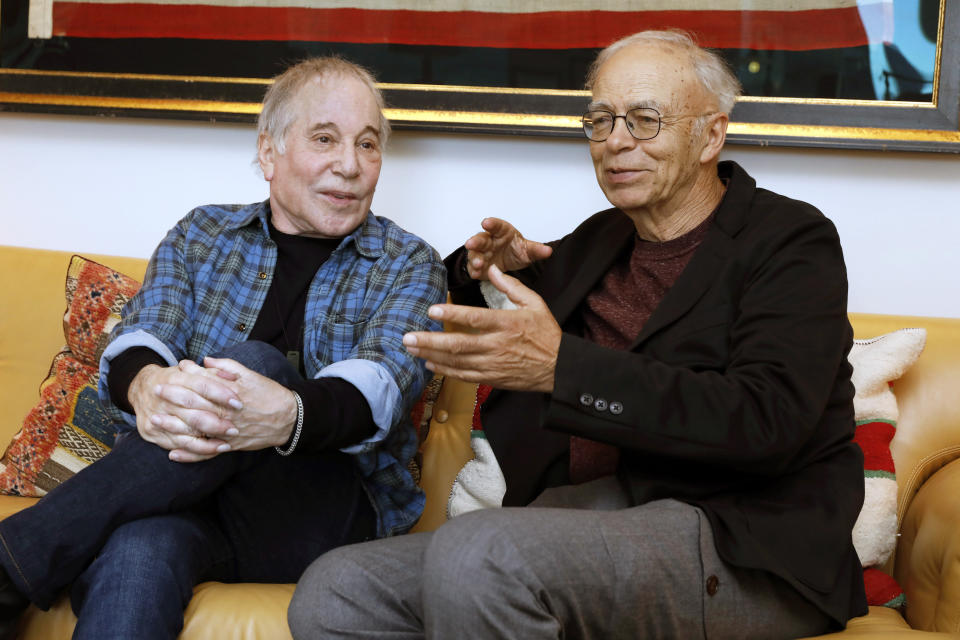 This Nov. 8, 2019 photo shows singer-songwriter, Paul Simon, left, and author-philosopher Peter Singer during an interview in New York to promote the new edition of Singer's book “The Life You Can Save." (AP Photo/Richard Drew)