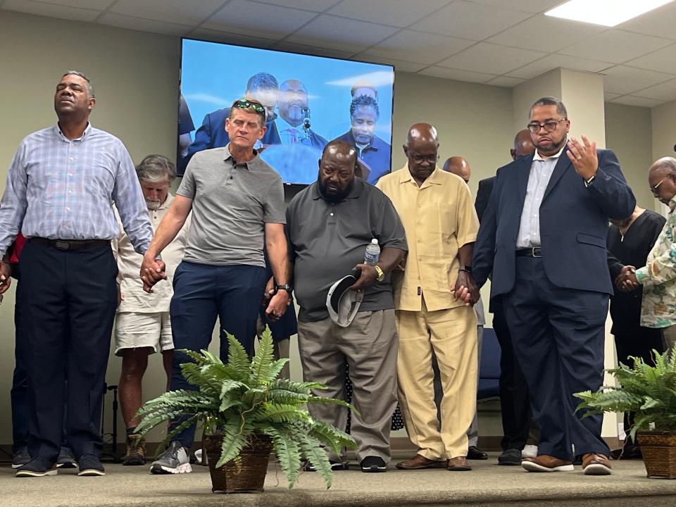 Area pastors and community leaders join hands in prayer in response to a hate message sent to three church communities in Columbia at Mt. Calvary Missionary Baptist Church in Columbia on July 12, 2023. (From left) Donald Coney, Russ Adcox, Carl McCullen, Talvin Barner and Trent Ogilvie.