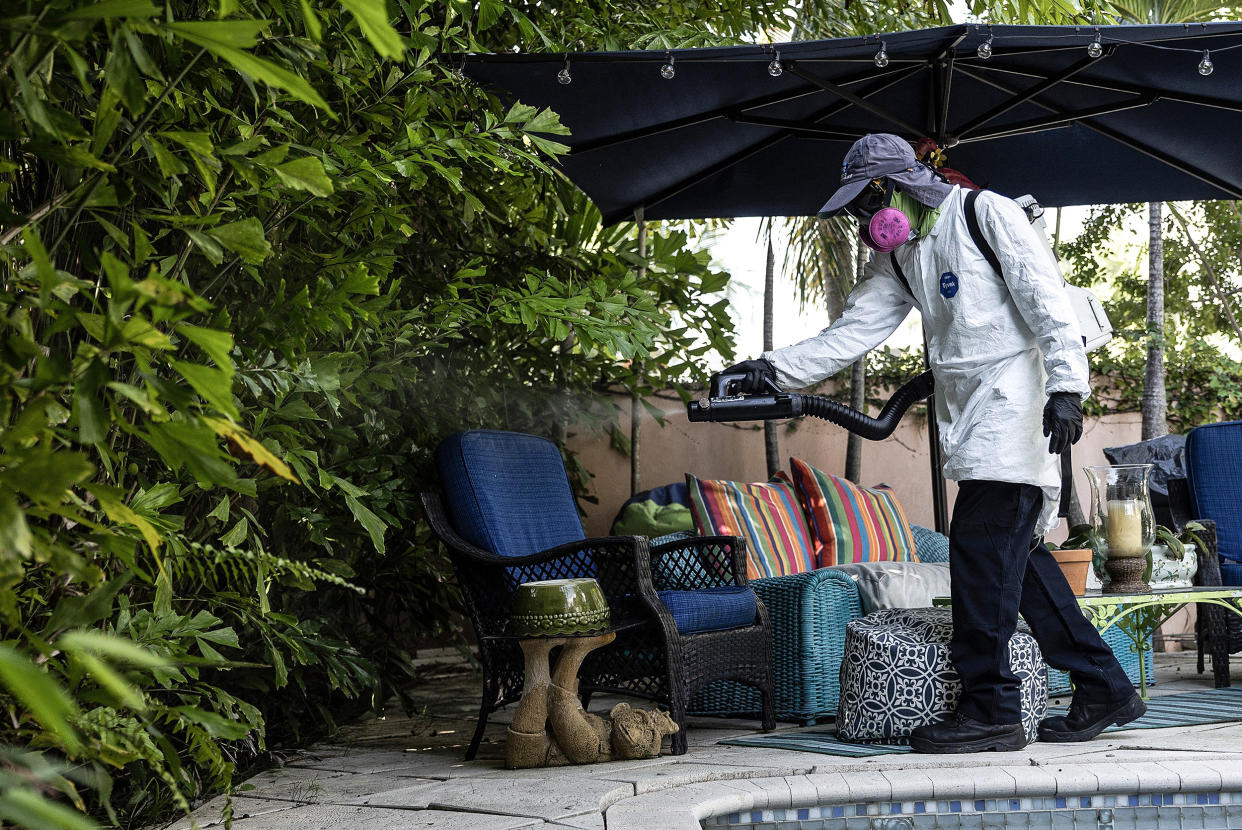 Image: Barrington Sanders, a Miami-Dade Mosquito Control Inspector, sprays a pesticide to kill adult mosquitos on June 29, 2023 in Miami. (Joe Raedle / Getty Images file)