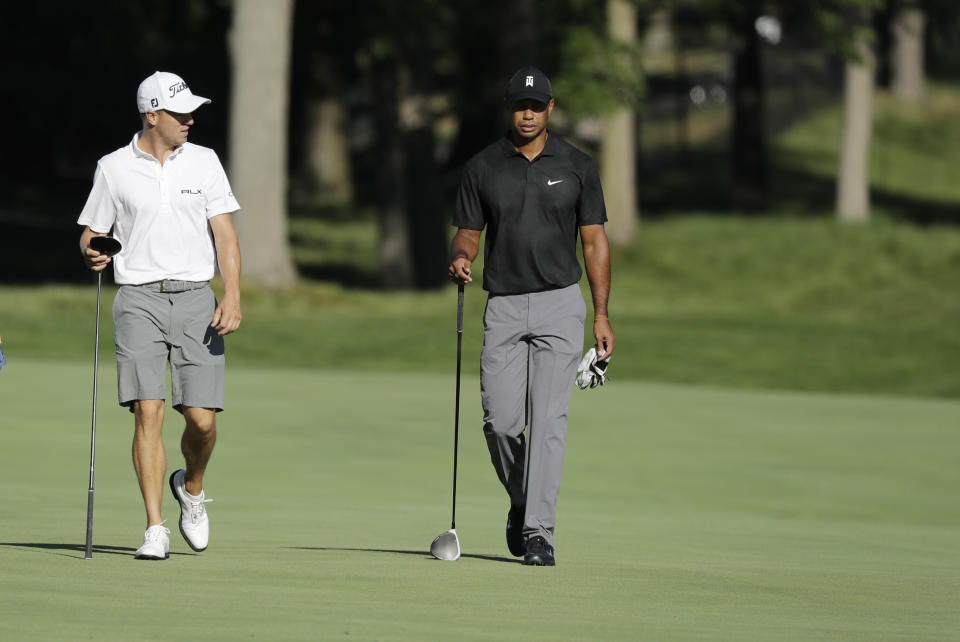 Justin Thomas, left, and Tiger Woods walk down the 13th fairway during a practice round for the Memorial golf tournament, Tuesday, July 14, 2020, in Dublin, Ohio. (AP Photo/Darron Cummings)