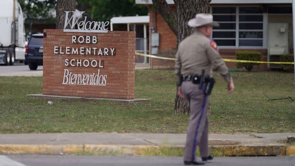 PHOTO: An officer walks outside of Robb Elementary School in Uvalde, Texas, May 24, 2022.  (Allison Dinner/AFP via Getty Images)