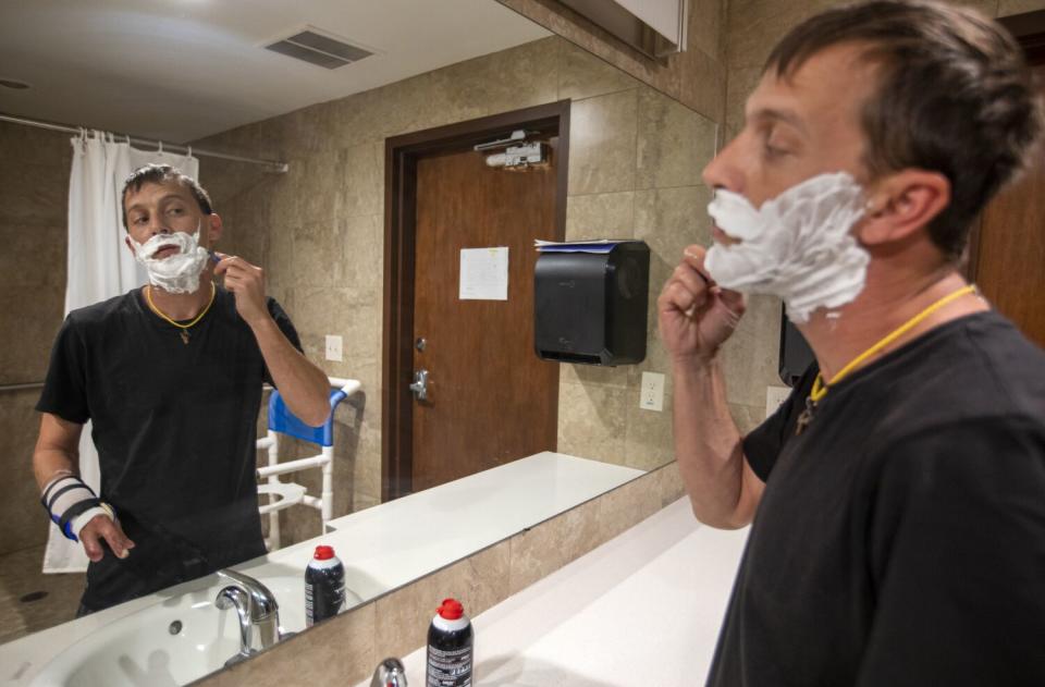 James Haley, a resident at the Inn Between, shaves before work.