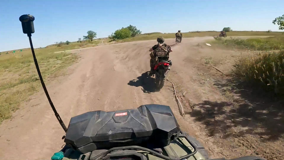 In this photo, taken from video released by the Russian Defense Ministry Press Service on Monday, July 1, 2024, Russian soldiers ride a quad bike and bikes changing their positions at the frontline in an undisclosed location in Ukraine. (Russian Defense Ministry Press Service via AP, File)