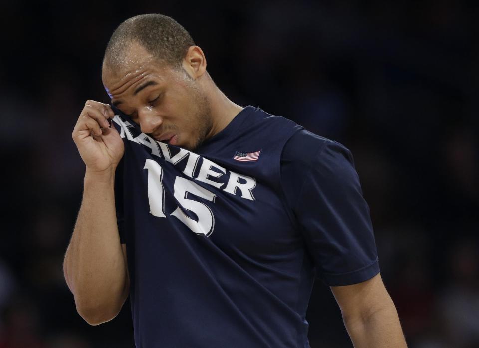 Xavier's Myles Davis (15) wipes his face during the first half of an NCAA college basketball game against Creighton in the semifinals of the Big East Conference men's tournament Friday, March 14, 2014, at Madison Square Garden in New York. (AP Photo/Frank Franklin II)