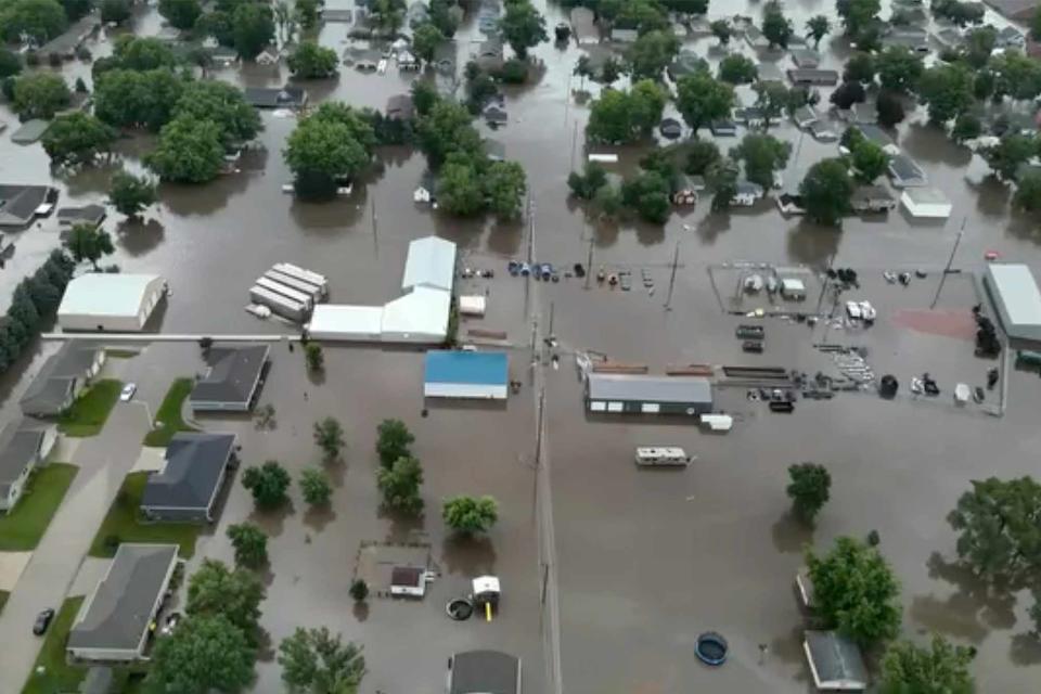 <p>Sioux County Sheriff via AP</p> The tops of houses and trees poke out from floodwater in Rock Valley, Iowa, on June 22, 2024