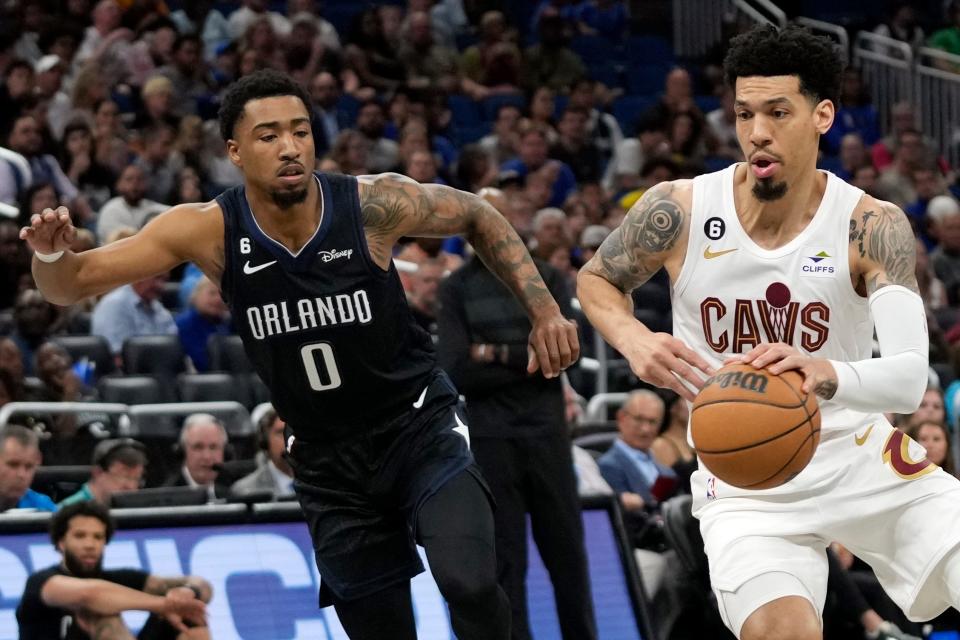 Cleveland Cavaliers' Danny Green, right, drives around Orlando Magic's Jay Scrubb (0) during the first half of an NBA basketball game Thursday, April 6, 2023, in Orlando, Fla. (AP Photo/John Raoux)