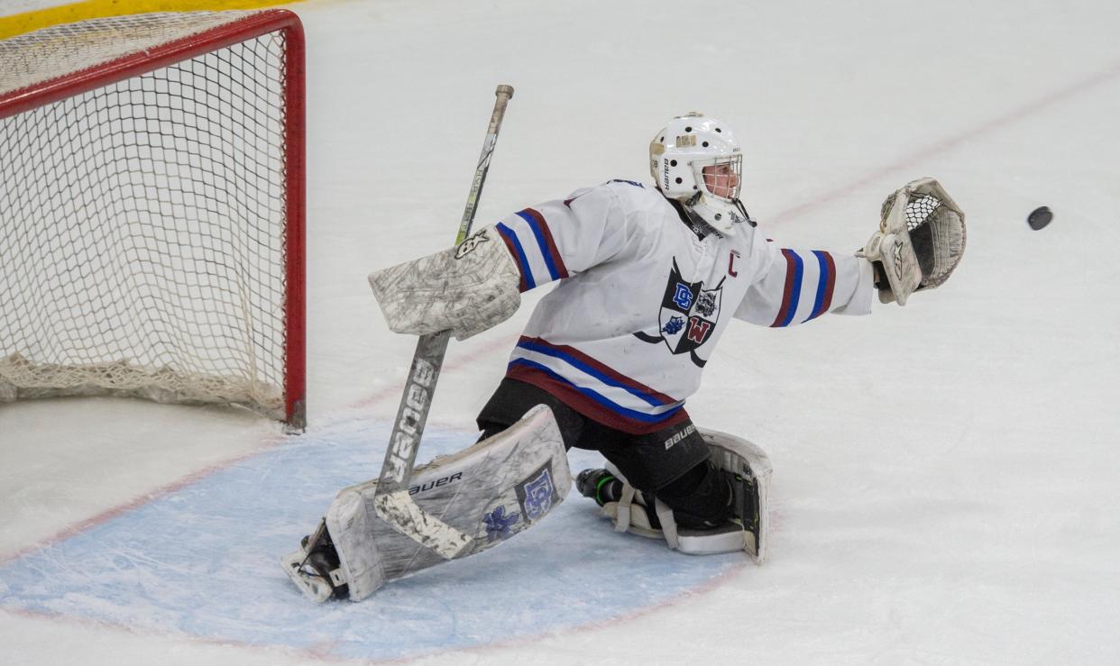 Dover-Sherborn Weston boys hockey goalie senior captain Andrew Goldstein with a save against Hopedale at the MacDowell Arena at Rivers, Feb. 12, 2024.