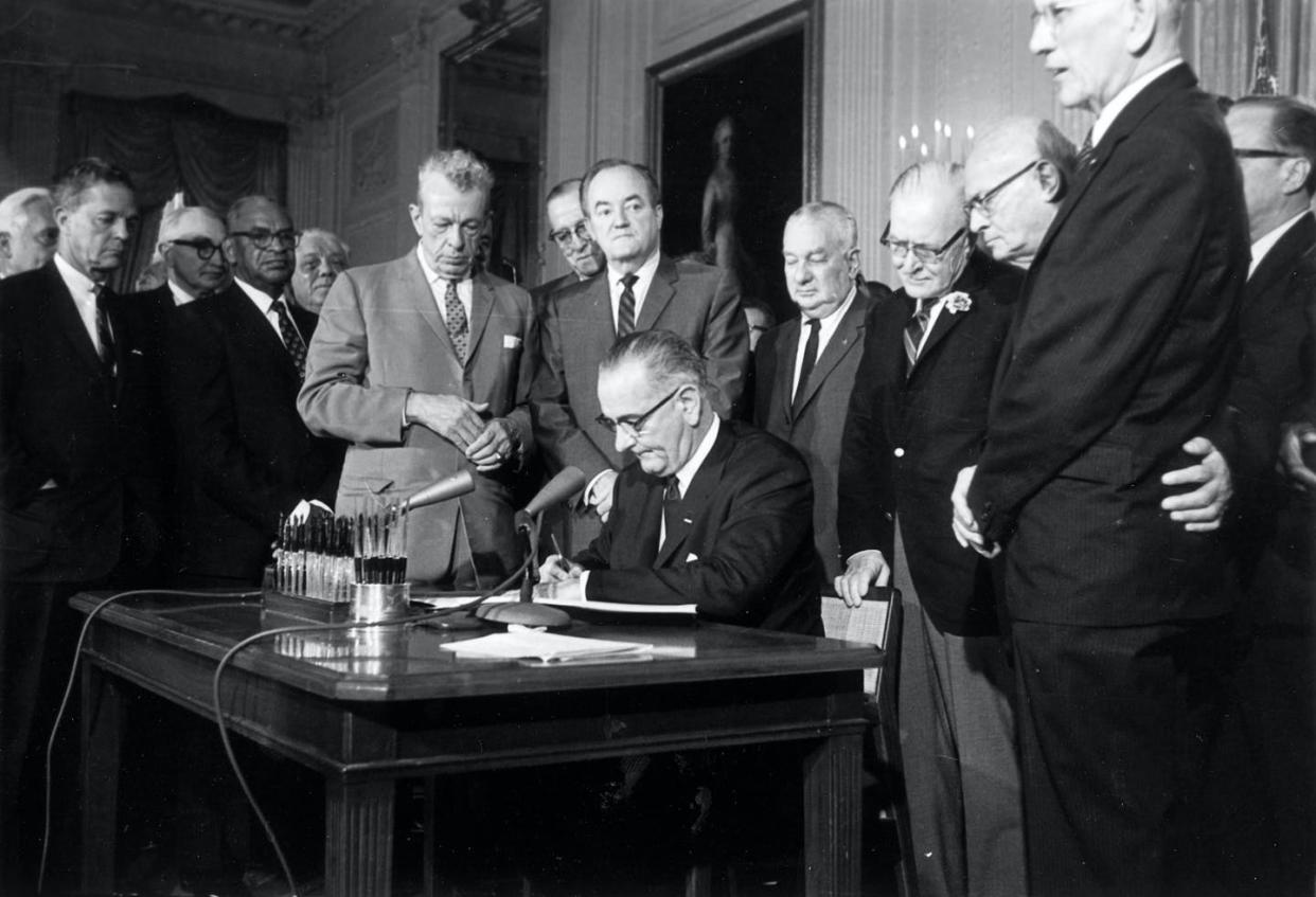 <span class="caption">President Lyndon Johnson signing the 1964 Civil Rights Act, which aimed to do away with racial discrimination in the law. But discrimination persisted.</span> <span class="attribution"><a class="link " href="https://newsroom.ap.org/detail/CivilRightsAct5Things/2bb46ead55594550b57e184e605c75e8/photo?Query=(renditions.phototype:horizontal)%20AND%20civil%20rights%20U.S.%20Johnson&mediaType=photo&sortBy=arrivaldatetime:desc&dateRange=Anytime&totalCount=72&currentItemNo=10" rel="nofollow noopener" target="_blank" data-ylk="slk:AP file photo;elm:context_link;itc:0;sec:content-canvas">AP file photo</a></span>