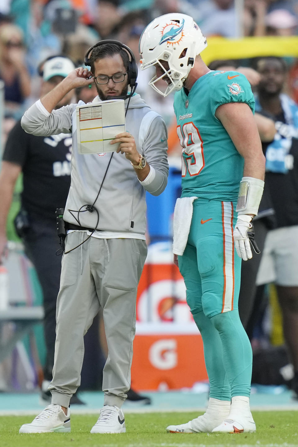 Miami Dolphins head coach Mike McDaniel talks to quarterback Skylar Thompson (19) during the second half of an NFL football game against the New York Jets, Sunday, Jan. 8, 2023, in Miami Gardens, Fla. (AP Photo/Lynne Sladky)
