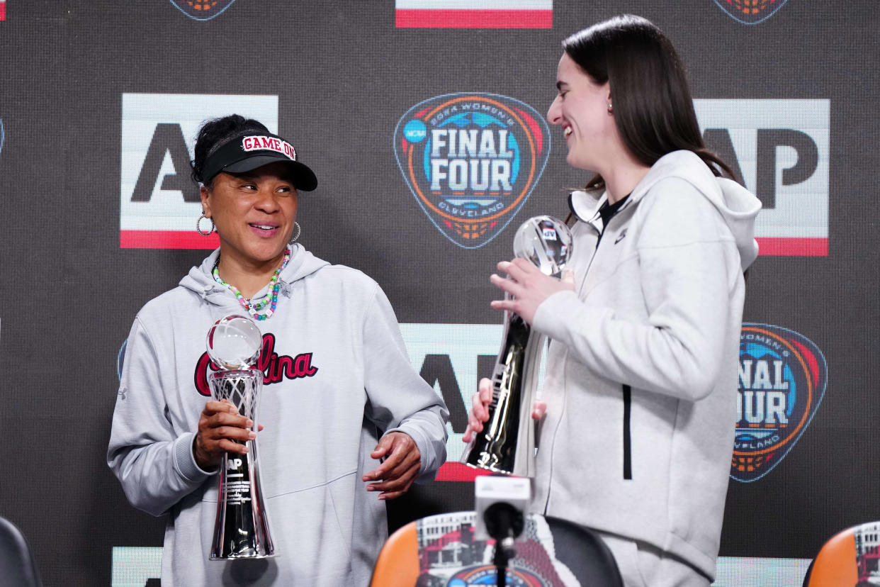 South Carolina Gamecocks coach Dawn Staley and Iowa Hawkeyes guard Caitlin Clark pose react after being selected as the AP Coach and Player of the Year.