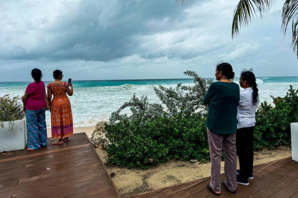 PHOTO: Tourists look at the sea waves as the hurricane Beryl passes near to Bridgetown, Barbados on July 1, 2024.  (Chandan Khanna/AFP via Getty Images)