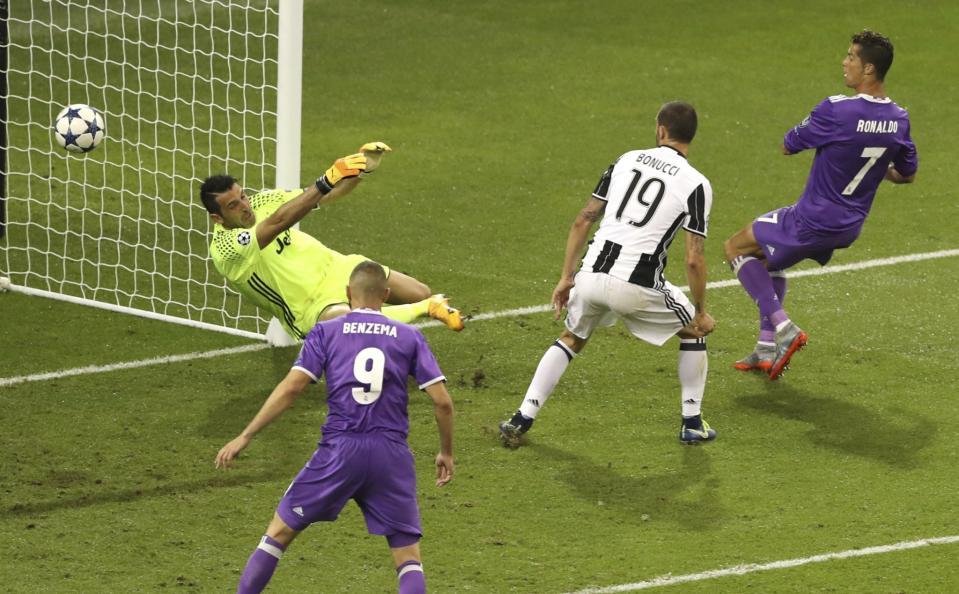 <p>Real Madrid’s Cristiano Ronaldo scores his side’s 3rd goal during the Champions League Final soccer match between Juventus and Real Madrid at the Millennium Stadium in Cardiff </p>