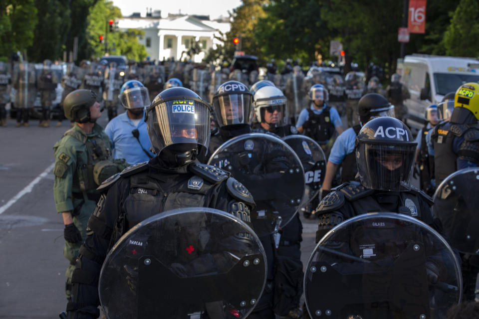 The White House looms in the background behind a line of law enforcement officers wearing riot gear as they push back demonstrators Friday in Washington. (Photo: JOSE LUIS MAGANA via Getty Images)