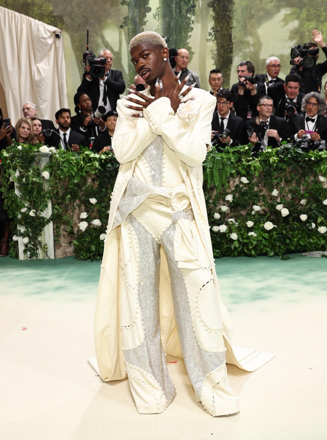 Lil Nas X wore a bedazzled, off-white three-piece suit by Luar.