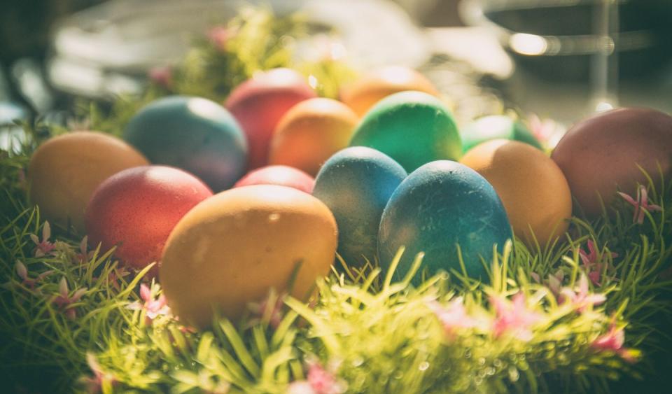 group of colorful dyed easter eggs in a patch of grass