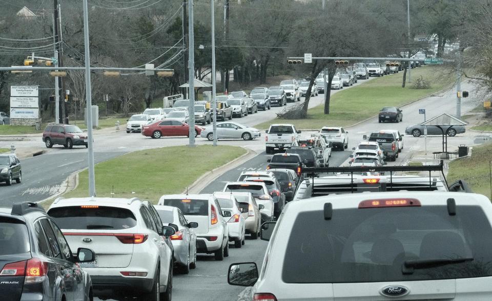 Traffic backs up at a residential intersection due to power outages in south Austin Friday, Feb. 3, 2023, after a winter storm earlier in the week. (AP Photo/Nell Carroll)