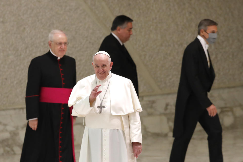 Pope Francis arrives in the Paul VI Hall at the Vatican for his weekly general audience, Wednesday, Oct. 28, 2020. Pope Francis has blamed “this lady COVID” for forcing him to keep his distance from the faithful during his general audience, which was far smaller than usual amid soaring coronavirus infections in Italy. (AP Photo/Alessandra Tarantino)