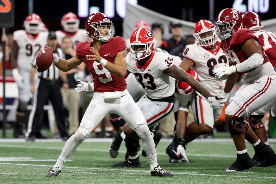 Alabama Crimson Tide quarterback Bryce Young attempts a pass against Georgia Bulldogs linebacker Robert Beal Jr. during the second quarter of the 2021 SEC championship game at Mercedes-Benz Stadium.