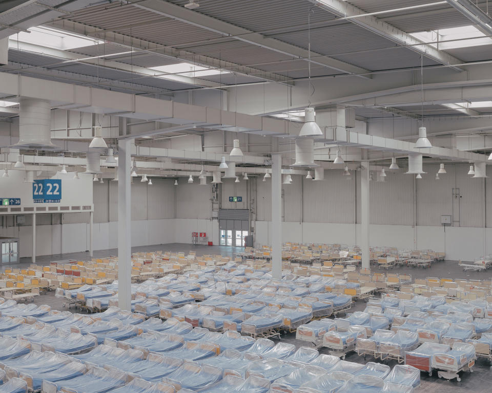 Hospital beds are set up on April 4 at a new hospital for treating coronavirus in an exhibition hall at the Hannover Messe trade fair in Hannover. Five hundred beds will be available across two halls. | Ingmar Björn Nolting—DOCKS Collective