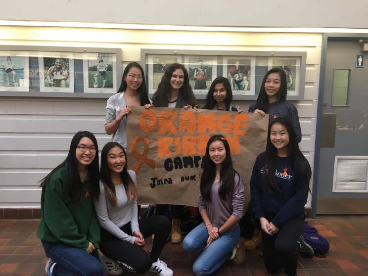 High school students from the MGCI Social Justice and Equity group, a student-led initiative at a Toronto school, pose for a picture for their orange ribbon campaign. Facebook 