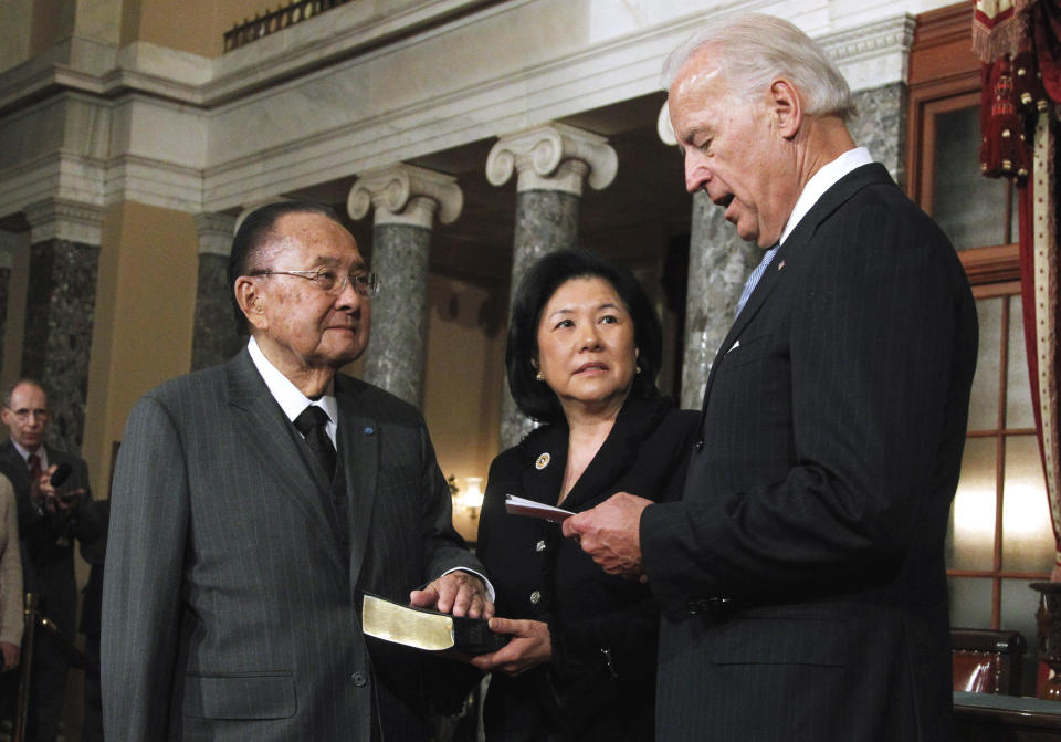 FILE - In this Jan. 5, 2011, file photo Vice President Joe Biden administers a ceremonial Senate oath of office during a mock swearing-in ceremony to Sen. Daniel Inouye, D-Hawaii, left, accompanied by his wife Irene Hirano, in the Old Senate Chamber on Capitol Hill in Washington. Hirano Inouye, the widow of the late senator and the founding CEO of the Japanese American National Museum in Los Angeles, died in Los Angeles on Tuesday, April 7, 2020. She was 71. Hirano Inouye had most recently served as president of the U.S.-Japan Council, which aims to develop and connect leaders to strengthen the U.S.-Japan relationship. (AP Photo/Manuel Balce Ceneta, File)