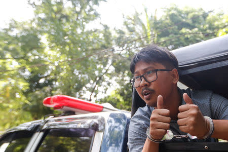 Detained Reuters journalist Wa Lone leaves the court handcuffed, in a police vehicle, after a hearing in Yangon, Myanmar May 21, 2018. REUTERS/Ann Wang