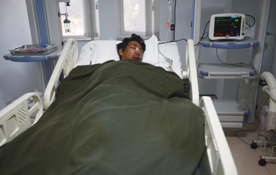 A Nepalese Sherpa Dawa Tashi, who was injured during an avalanche, gets treatment at a hospital in Katmandu, Nepal, Friday, April 18, 2014. An avalanche swept down a climbing route on Mount Everest early Friday, killing at least 12 Nepalese guides and leaving three missing in the deadliest disaster on the world's highest peak. (AP Photo/Niranjan Shrestha)