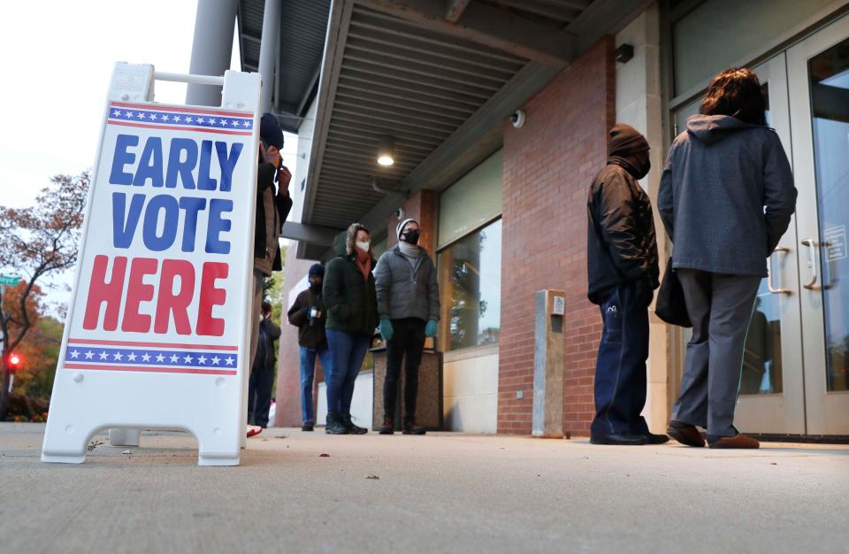 Milwaukee residents are lined up early outside the Washington Park Library to cast their ballots during early voting on Tuesday. Beginning Oct. 20, Wisconsin voters will have an 11-day window to vote early in their municipalities. Early voting is technically absentee voting and those ballots will be stored and opened on Election Day.