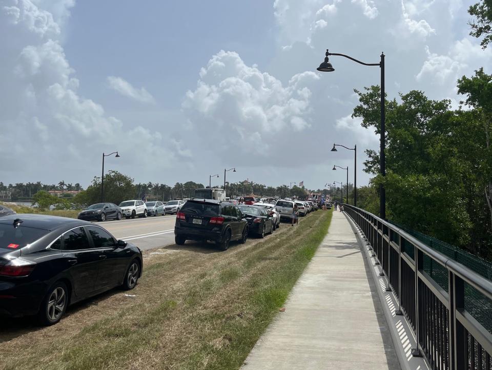 Trump supporters lined up on the bridge leading out to Mar-a-Lago.