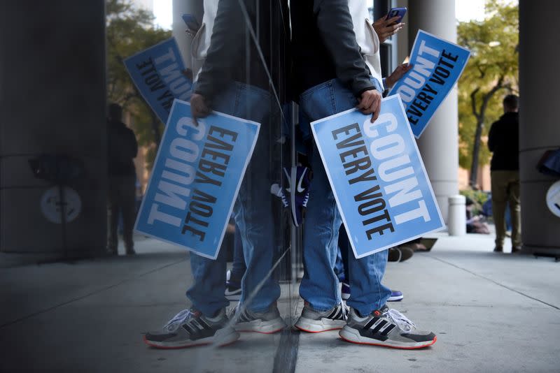 People gather to protest outside of a federal courthouse where a judge is deciding whether to throw out ballots cast at drive-through polling locations in Houston