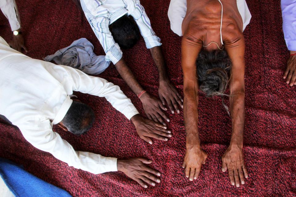 Naga Sadhu (Naked holy man) perform yoga to the villagers on first world yoga day at Dhaulpur. Naga Sadhus are a particular group of Shaivite saints who reside in the Himalayan Caves and come to visit the civilization only during the Kumbh Mela, but this time Naga Rajiv Giri who belongs from Juna akahara take responsibility to aware the villagers for yoga on first world yoga day. (Shashi Sharma/Pacific Press/LightRocket via Getty Images)