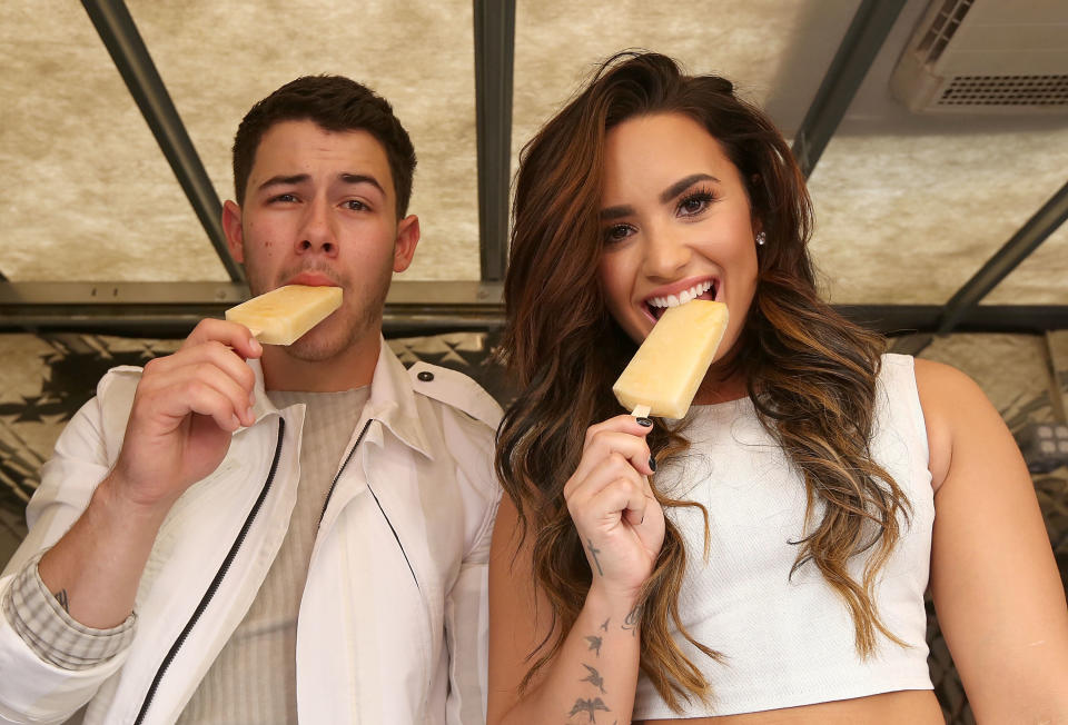 Nick Jonas and Demi Lovato hand out sweet treats and tickets to Demi Lovato's sold out show in Los Angeles.