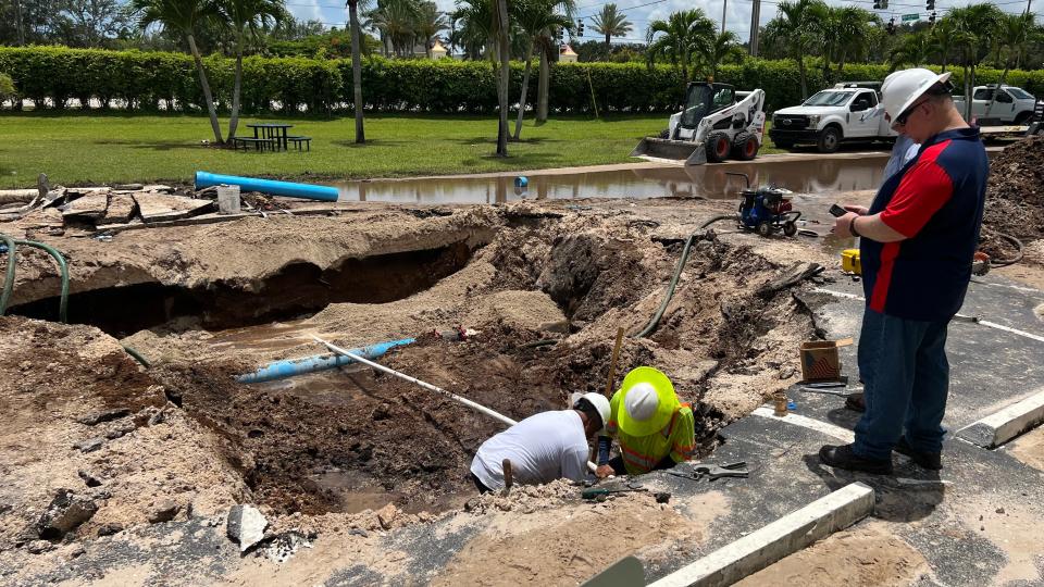 Palm Beach County water utility workers repair a water main break Saturday at the Kings Point complex west of Delray Beach.