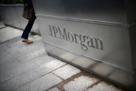 A man walks into the JP Morgan headquarters at Canary Wharf in London May 11, 2012. REUTERS/Dylan Martinez/File Photo