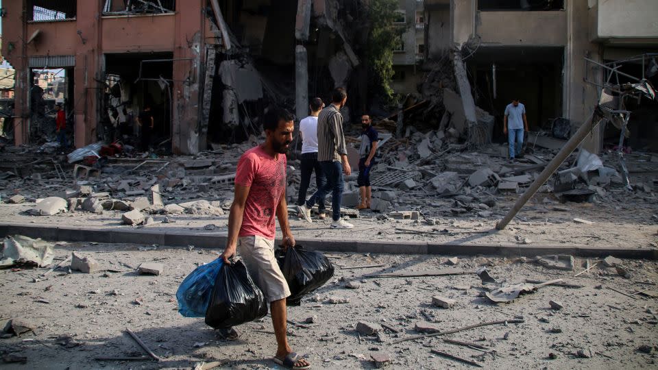 Palestinian citizens inspect damage to their homes, which were destroyed by Israeli airstrikes in the Karama area, in northern Gaza, on Wednesday. - Ahmad Hasaballah/Getty Images