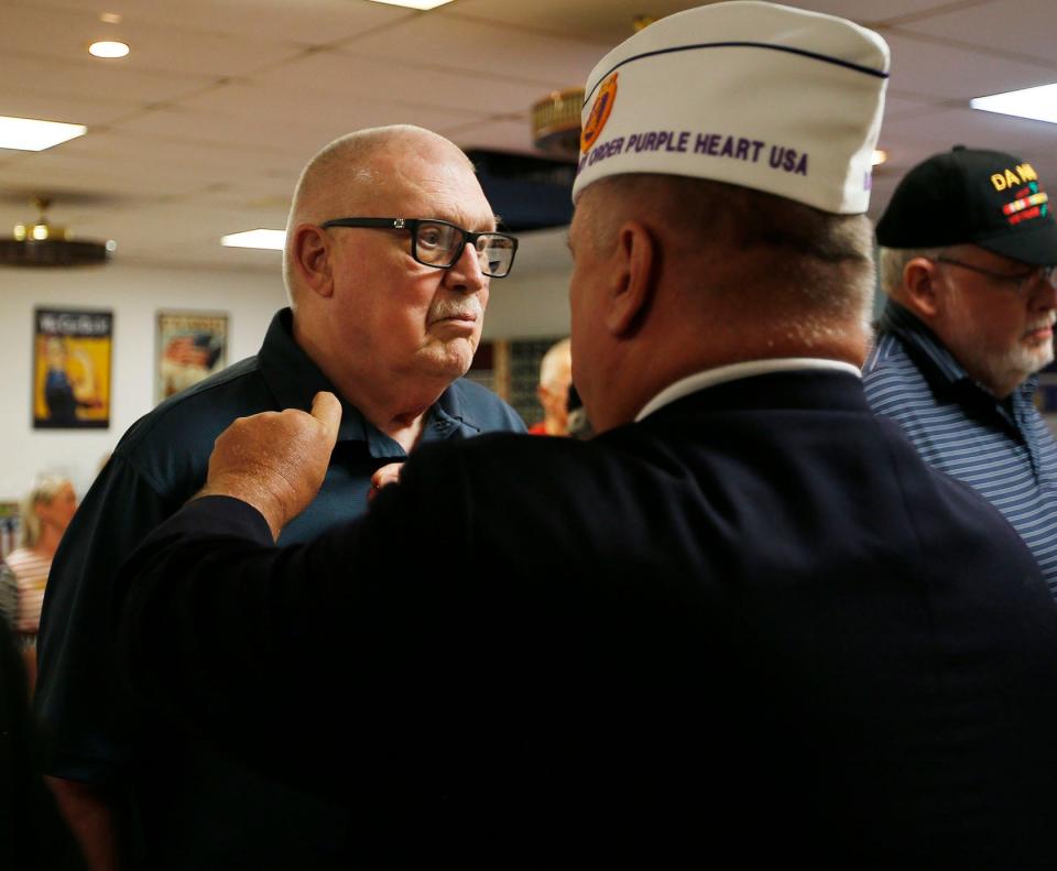 Charles Hollibough receives his pin from Carder Ferguson during a Vietnam War commemorative ceremony at Jim Taylor VFW Post 8845 June 16, 2022, in Fort Smith.