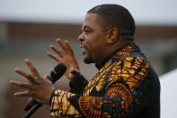 Artist Kehinde Wiley gestures during the unveiling ceremony for his statue titled Rumor's of War at the Virginia Museum of Dine arts in Richmond, Va., Tuesday, Dec. 10, 2019. Unfortunately the tarp covering the statue got stuck on the statue during the ceremony. (AP Photo/Steve Helber)